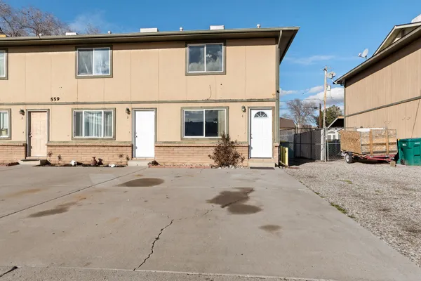 a front view of a house with a road