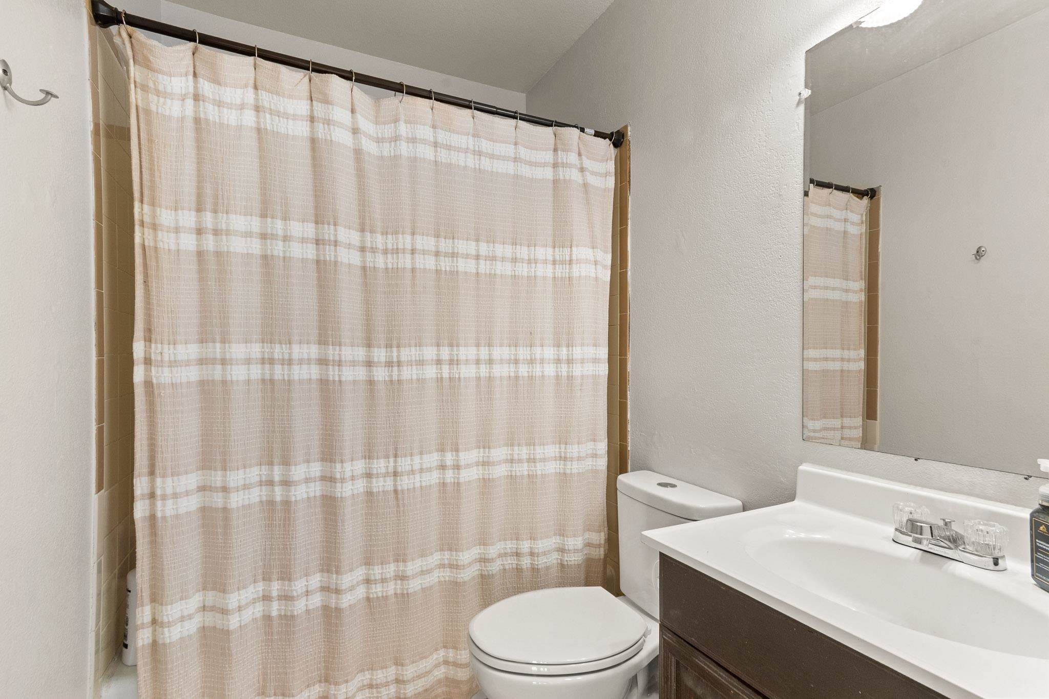 559 West Pabor Way, Unit 4 Fruita, CO 81521 - Photo 11 of 16 a bathroom with a sink a toilet and shower curtain