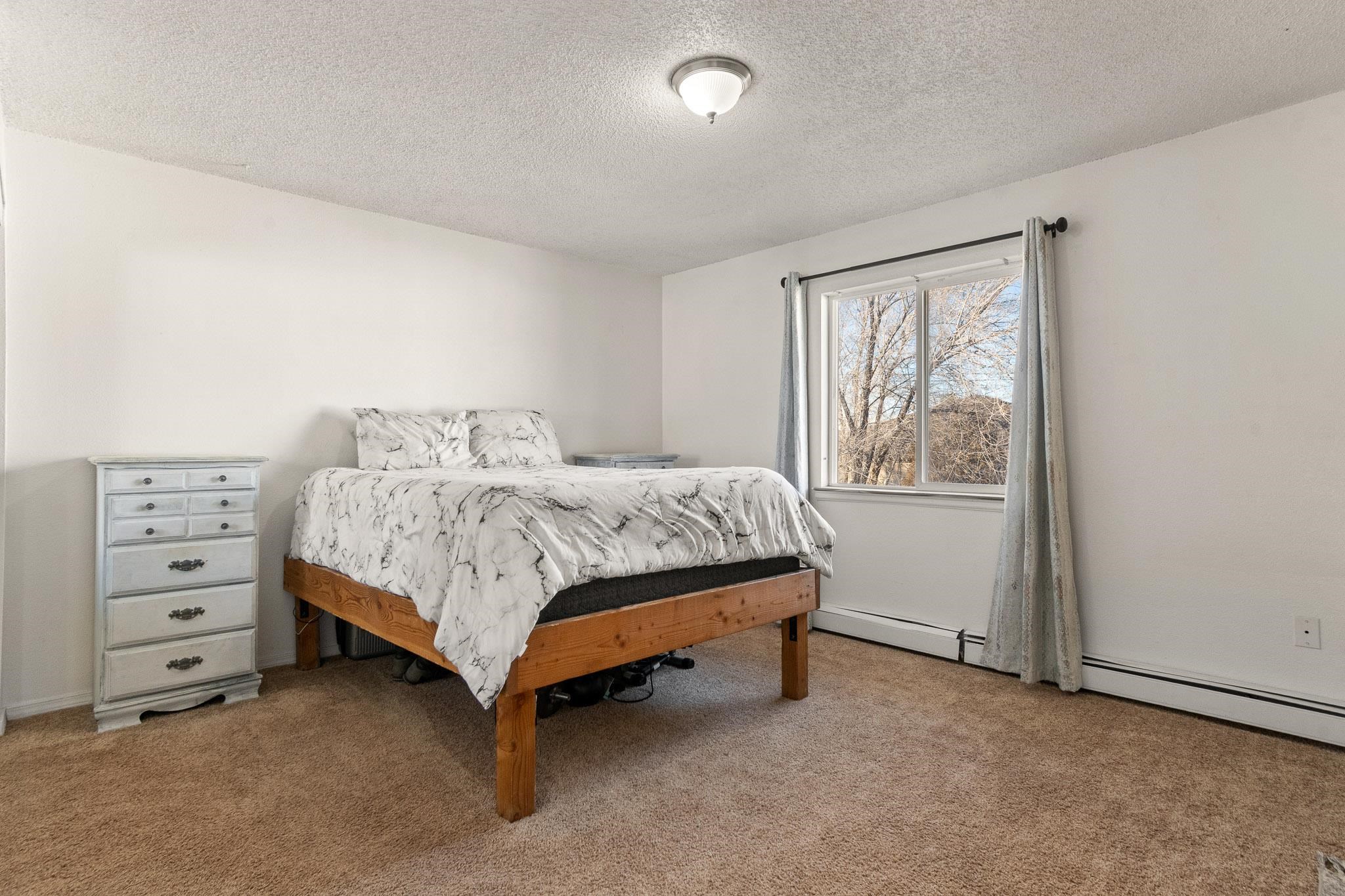 559 West Pabor Way, Unit 4 Fruita, CO 81521 - Photo 9 of 16 a bedroom with a bed and a window