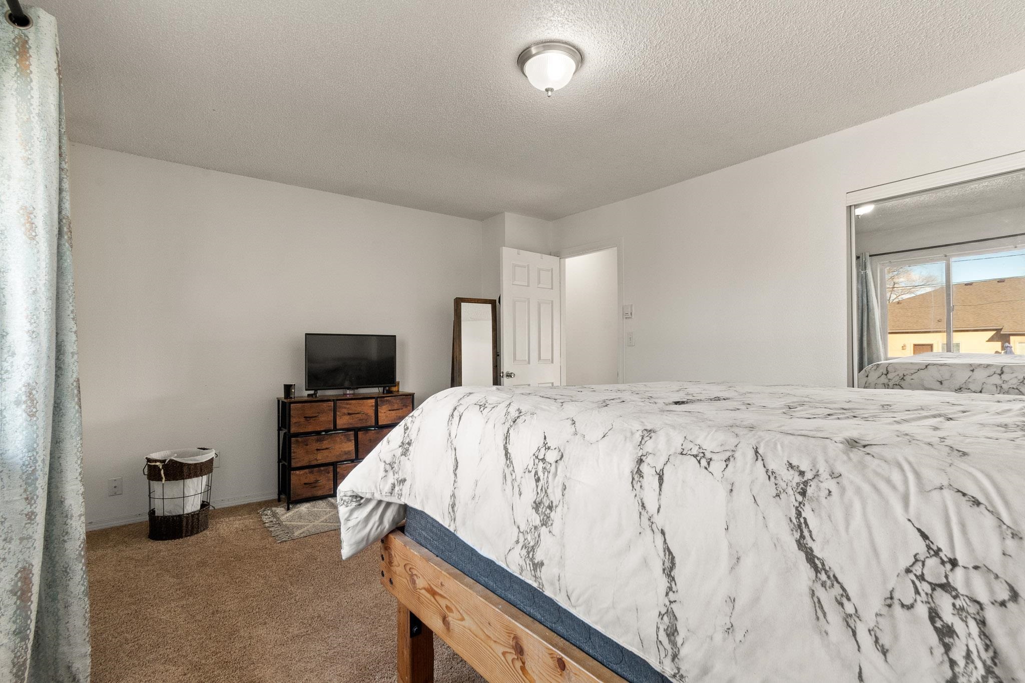 559 West Pabor Way, Unit 4 Fruita, CO 81521 - Photo 10 of 16 a bedroom with a bed and a television