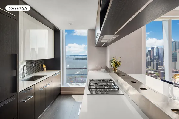 a kitchen with a stove a refrigerator and wooden floor