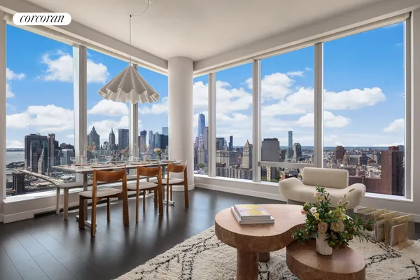 a living room with furniture and a floor to ceiling window