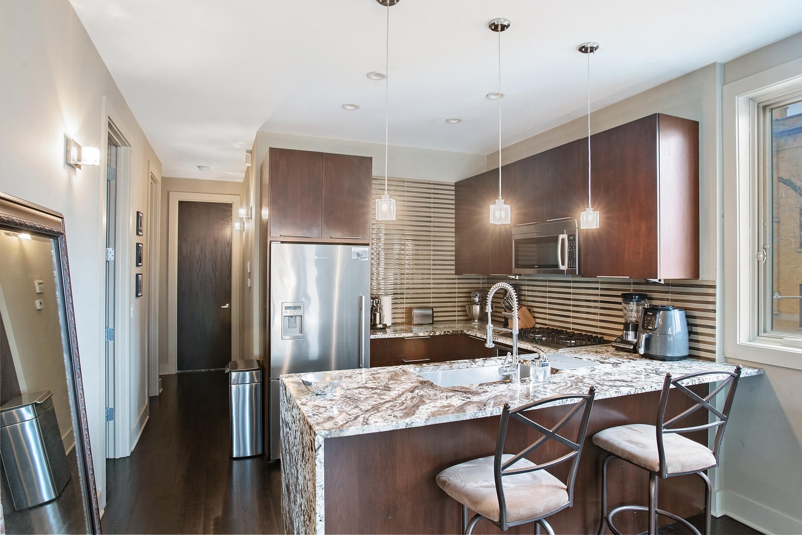 1257 West Addison Street, Unit 2 Chicago, IL 60613 - Photo 5 of 11 a bathroom with a granite countertop sink and a mirror