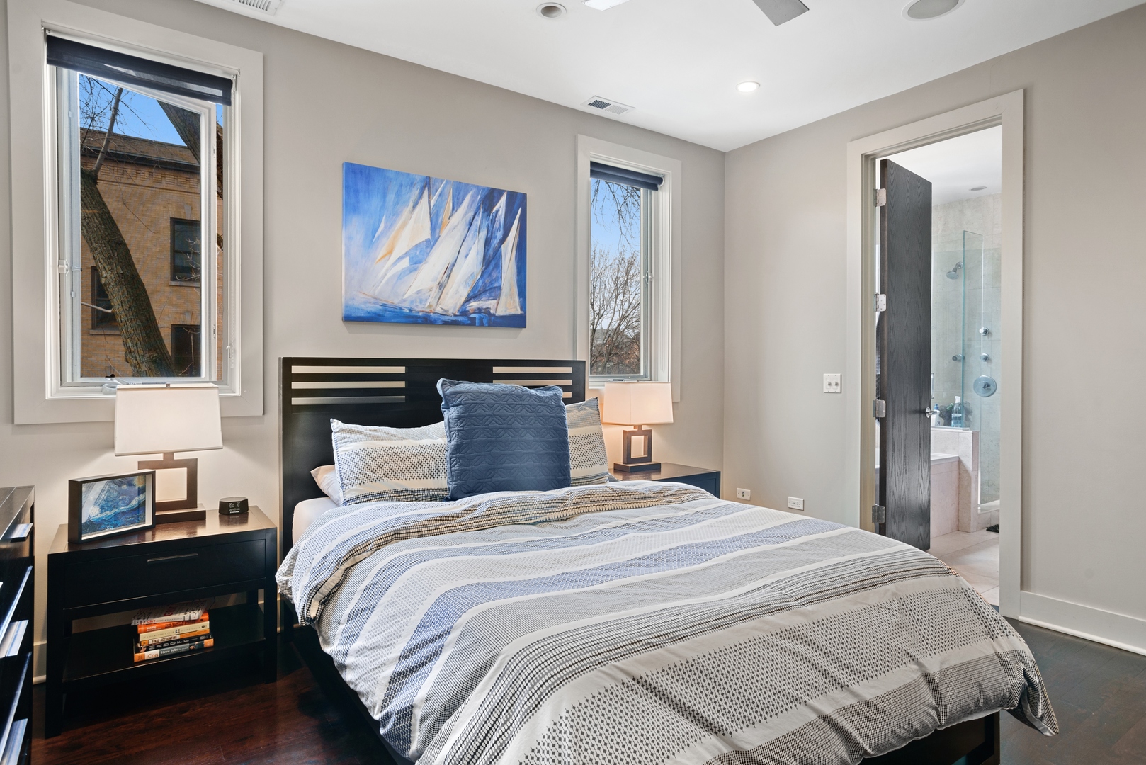 1257 West Addison Street, Unit 2 Chicago, IL 60613 - Photo 8 of 11 a bedroom with a bed and a painting on the wall