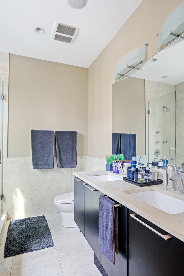 1257 West Addison Street, Unit 2 Chicago, IL 60613 - Photo 9 of 11 a bathroom with a sink and a mirror