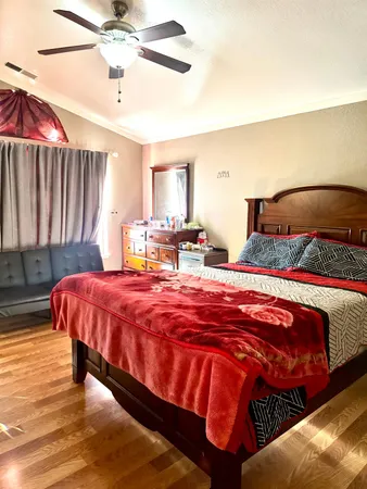 a bedroom with a bed and a chandelier