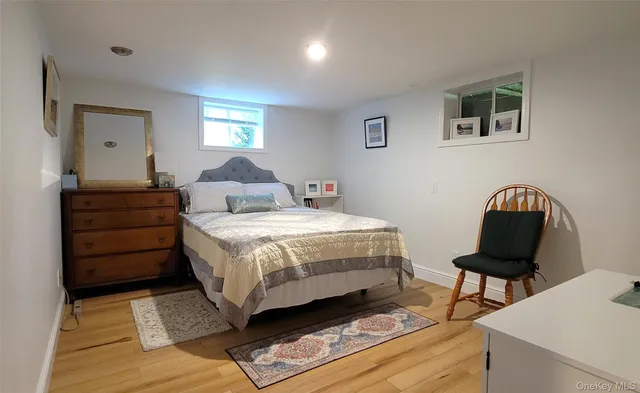 a bedroom with a bed window and a chair