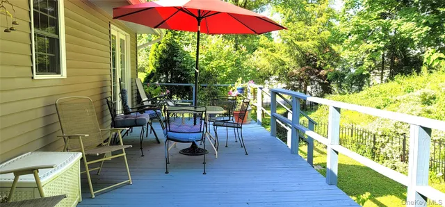 a view of a chairs and table in the balcony