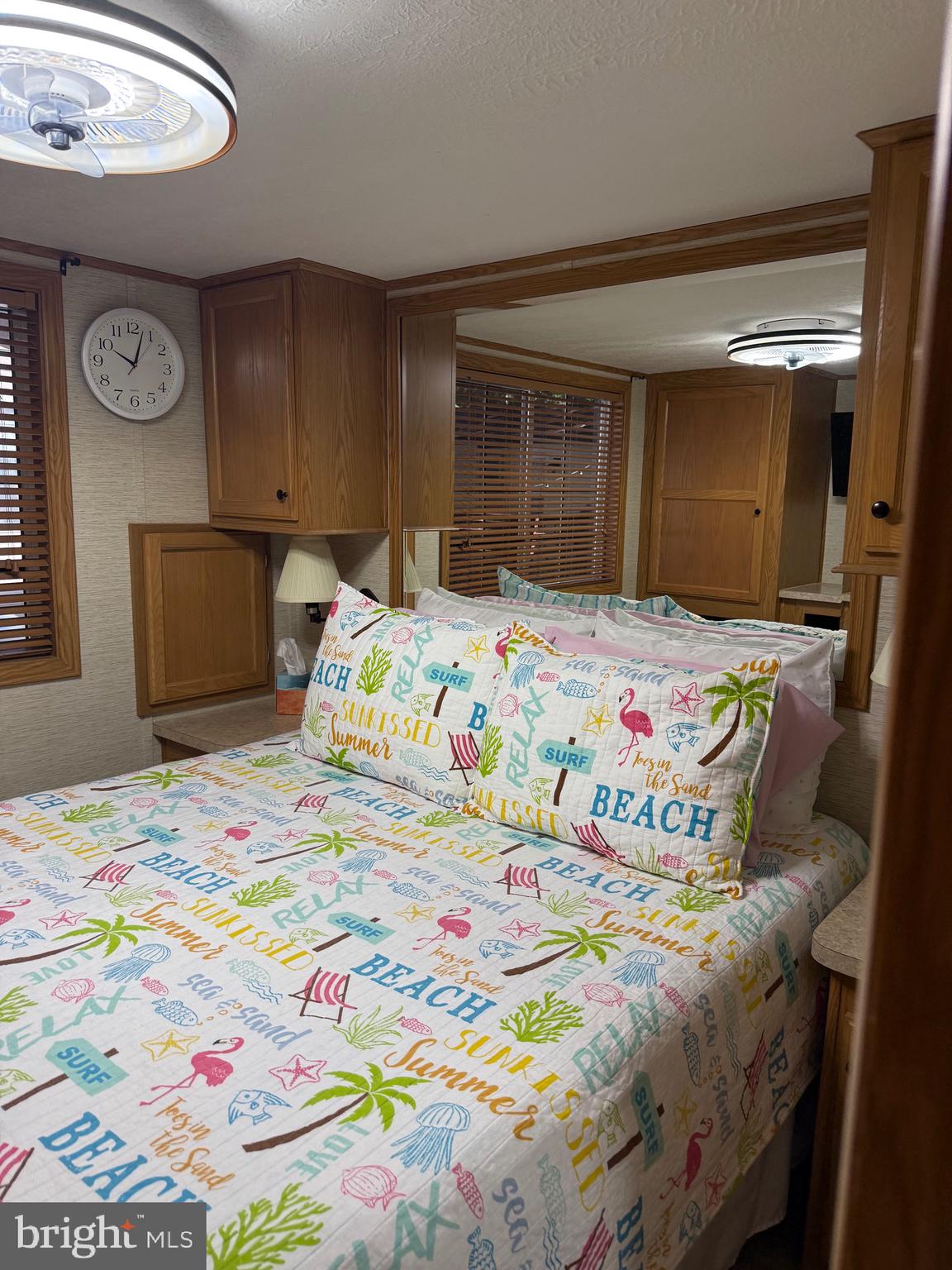 515 Corsons Tavern Road, Unit E51 Ocean View, NJ 08230 - Photo 5 of 12 a bedroom with a bed and a window