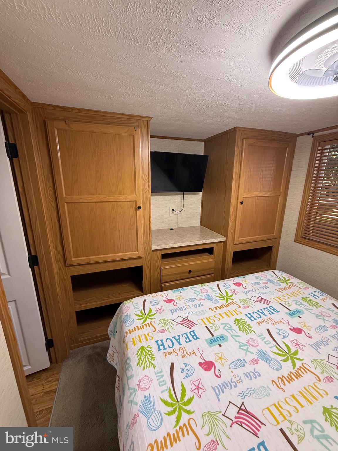 515 Corsons Tavern Road, Unit E51 Ocean View, NJ 08230 - Photo 6 of 12 a bedroom with a bed and a window