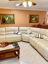 a living room with couch and a dining table