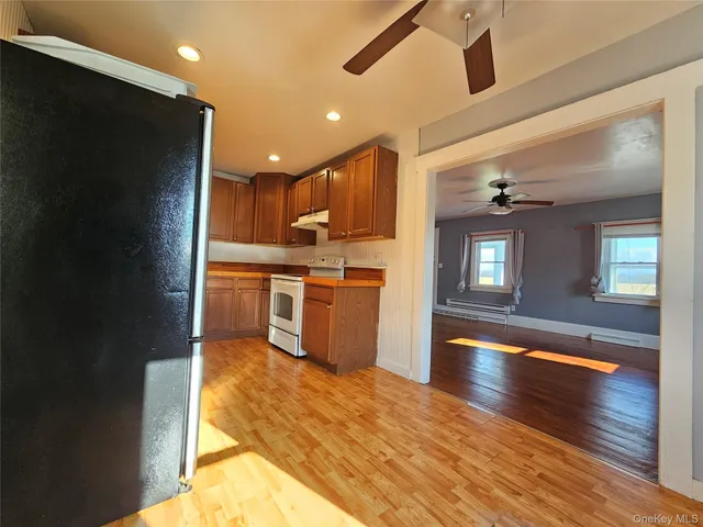 a view of kitchen with cabinets and wooden floor