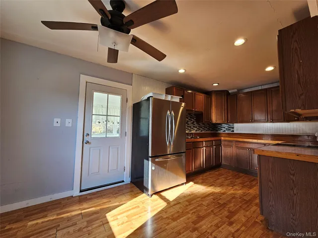 a kitchen with stainless steel appliances granite countertop a refrigerator and a sink