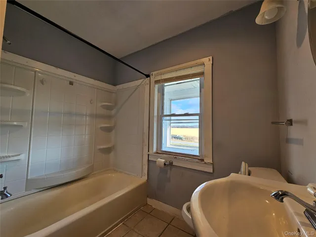 a bathroom with a tub and a shower