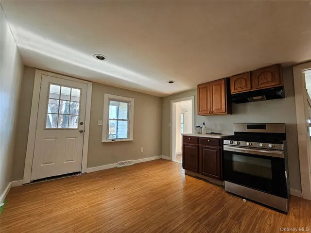 a kitchen with stainless steel appliances a stove a sink and a microwave