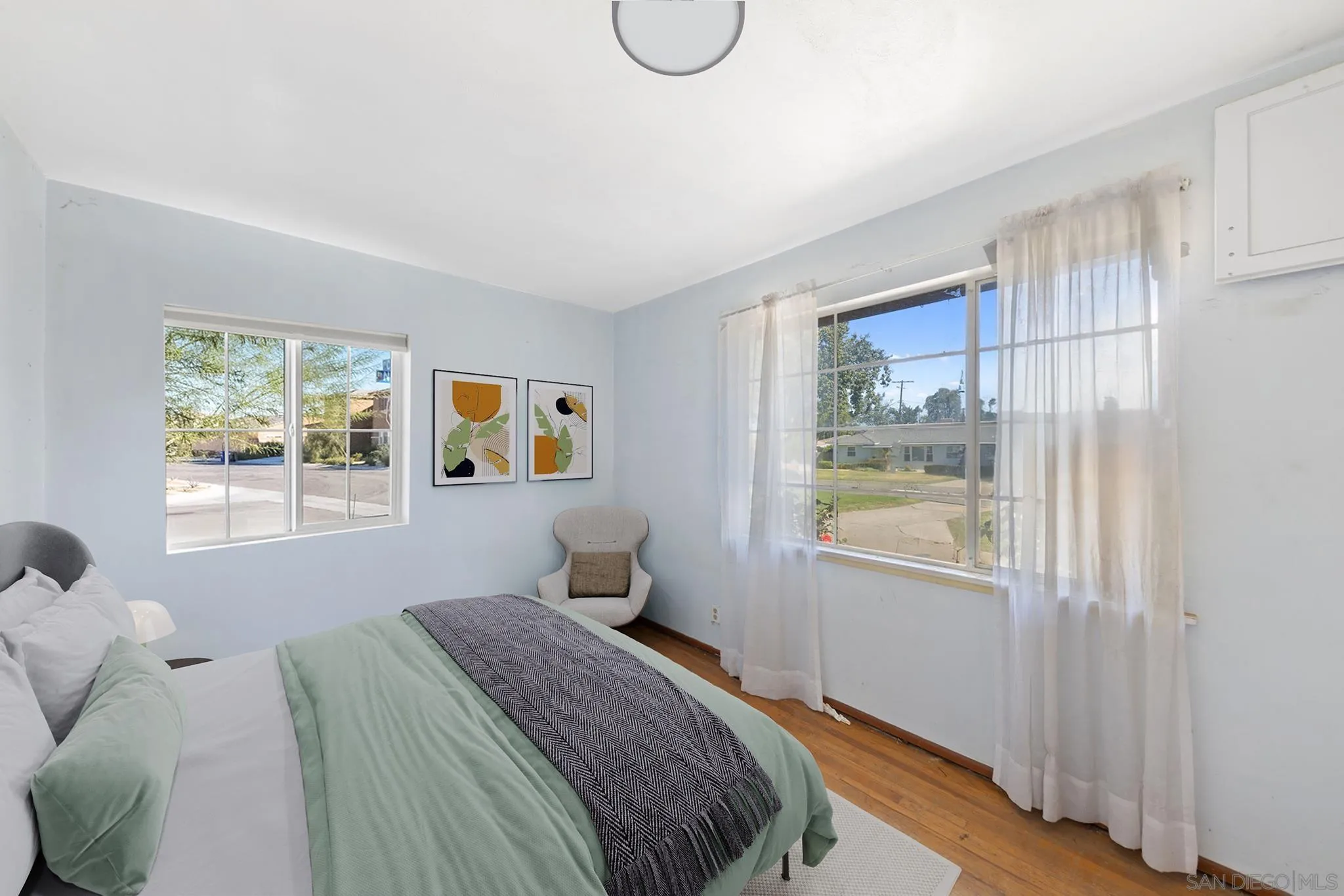 4690 Jarvis Street Riverside, CA 92506 - Photo 8 of 16 a bedroom with a bed and wooden floor