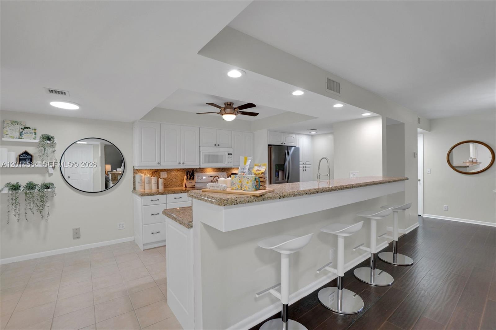 a kitchen with a sink a stove and cabinets