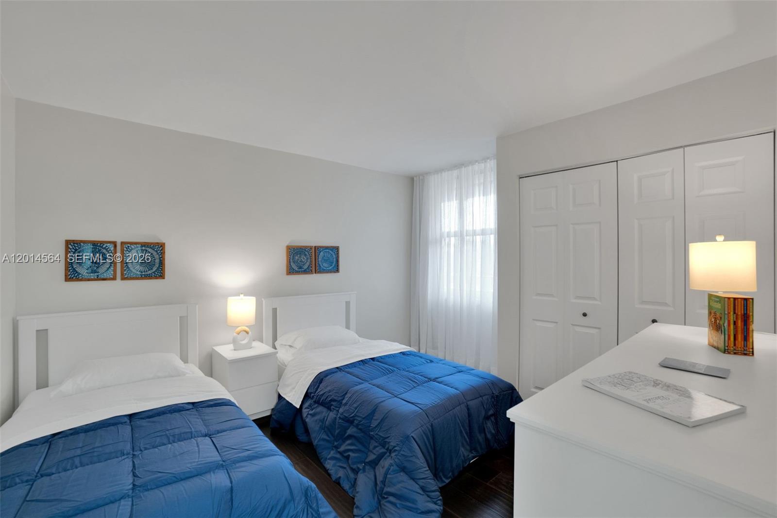 500 Egret Circle, Unit 8403 Delray Beach, FL 33444 - Photo 18 of 32 a bedroom with two beds and a lamp