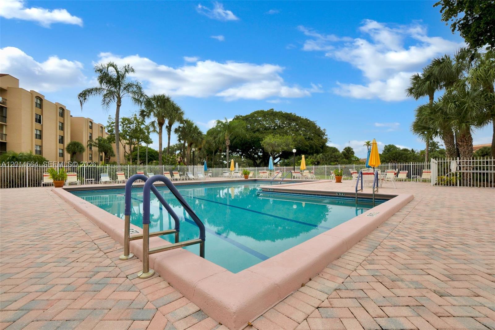 500 Egret Circle, Unit 8403 Delray Beach, FL 33444 - Photo 24 of 32 a view of swimming pool with outdoor seating and city view