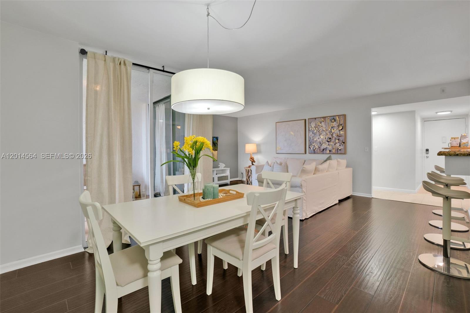 500 Egret Circle, Unit 8403 Delray Beach, FL 33444 - Photo 10 of 32 a view of a dining room with furniture and wooden floor