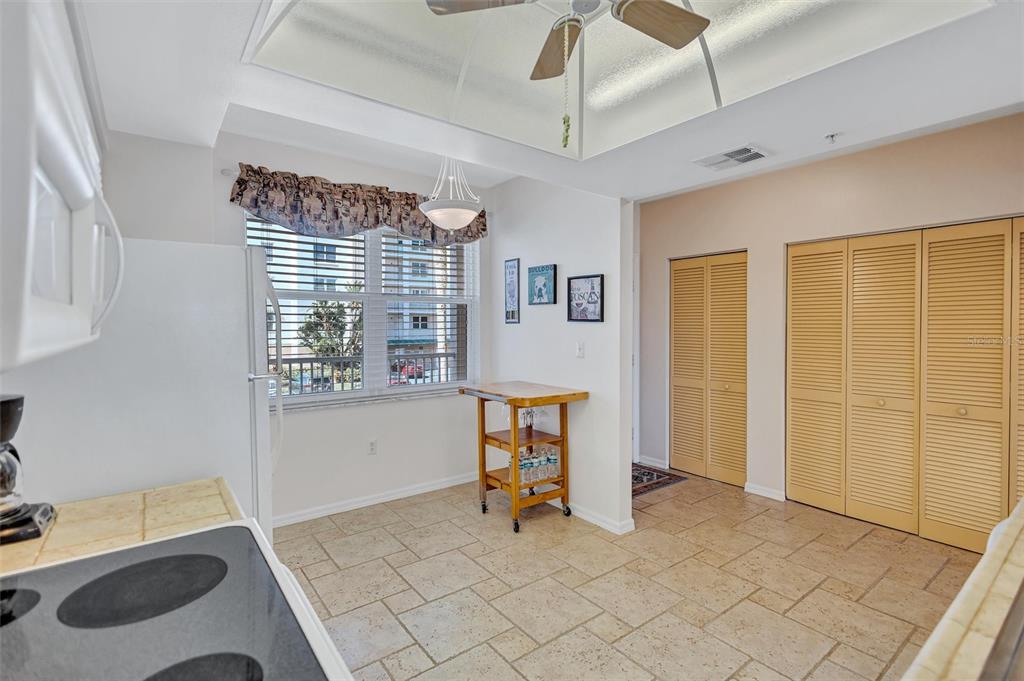 6475 Shoreline Drive, Unit 5102 St. Petersburg, FL 33708 - Photo 13 of 39 a view of an empty room with window and cabinet area