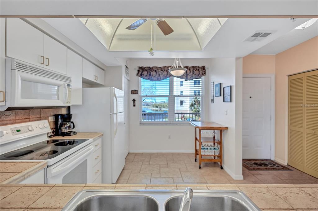 6475 Shoreline Drive, Unit 5102 St. Petersburg, FL 33708 - Photo 14 of 39 a kitchen with stainless steel appliances granite countertop a refrigerator and a stove