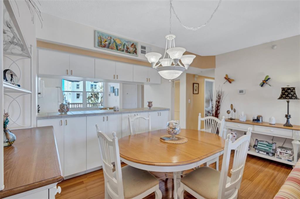 6475 Shoreline Drive, Unit 5102 St. Petersburg, FL 33708 - Photo 15 of 39 a view of a dining room with furniture and wooden floor