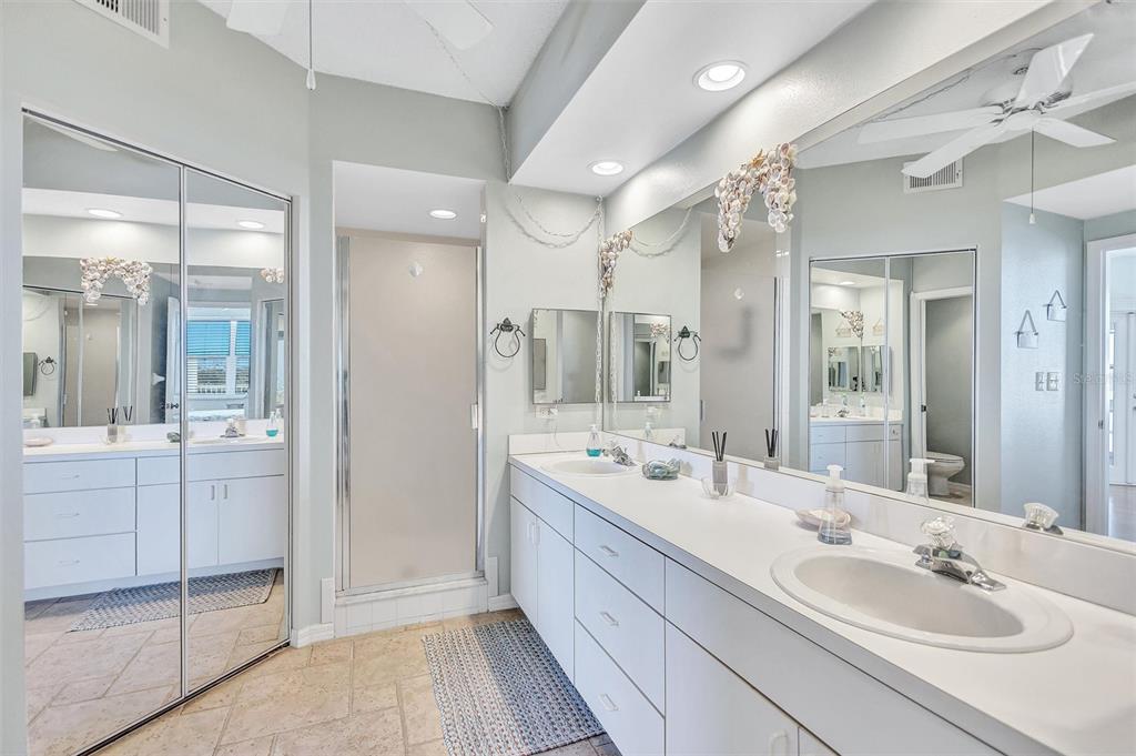 6475 Shoreline Drive, Unit 5102 St. Petersburg, FL 33708 - Photo 20 of 39 a bathroom with a double vanity sink mirror and double