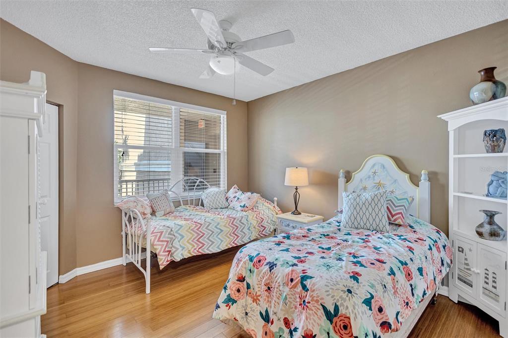 6475 Shoreline Drive, Unit 5102 St. Petersburg, FL 33708 - Photo 23 of 39 a bedroom with two beds and a window
