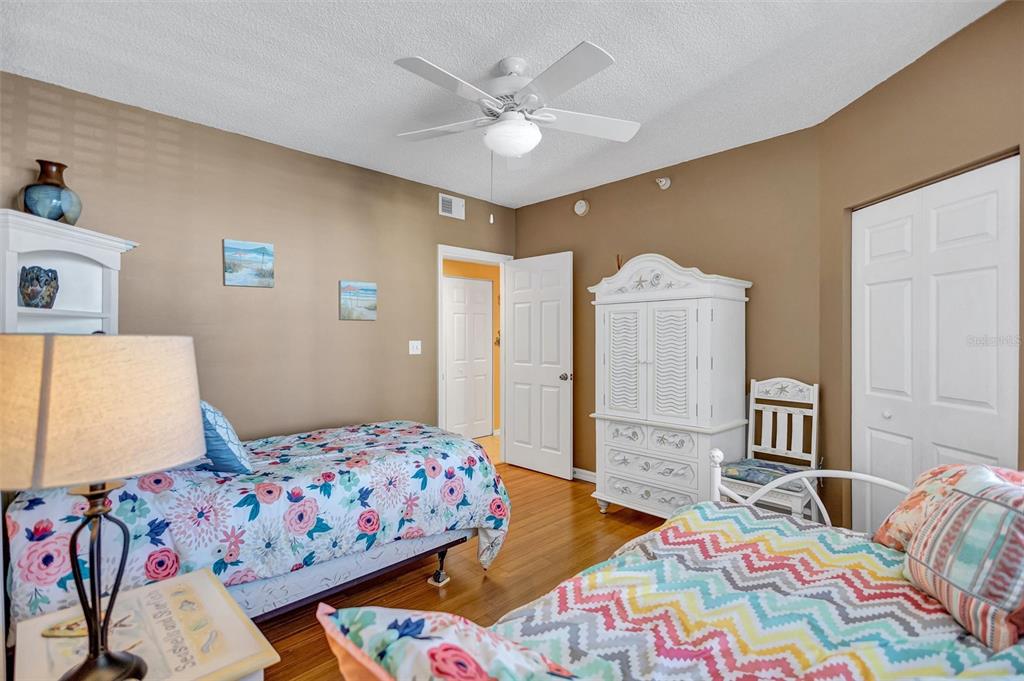 6475 Shoreline Drive, Unit 5102 St. Petersburg, FL 33708 - Photo 24 of 39 a bedroom with a bed and wooden floor