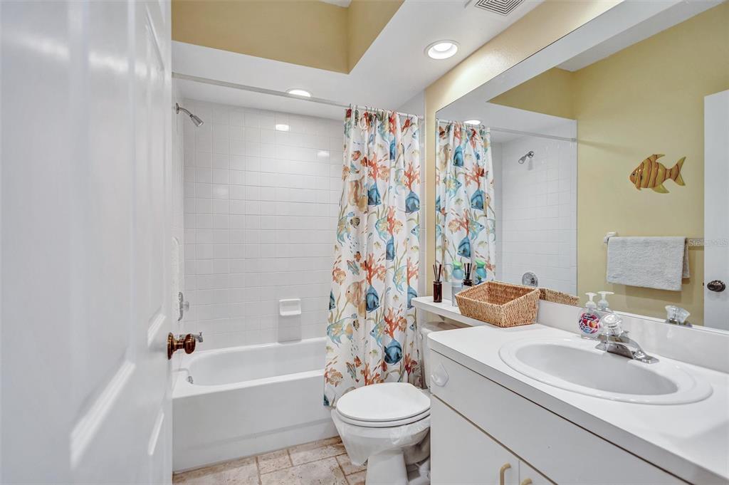 6475 Shoreline Drive, Unit 5102 St. Petersburg, FL 33708 - Photo 25 of 39 a bathroom with a sink a toilet and shower