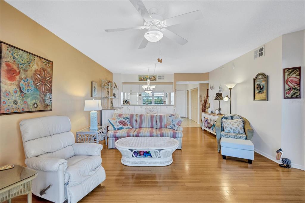 6475 Shoreline Drive, Unit 5102 St. Petersburg, FL 33708 - Photo 8 of 39 a living room with furniture and a wooden floor
