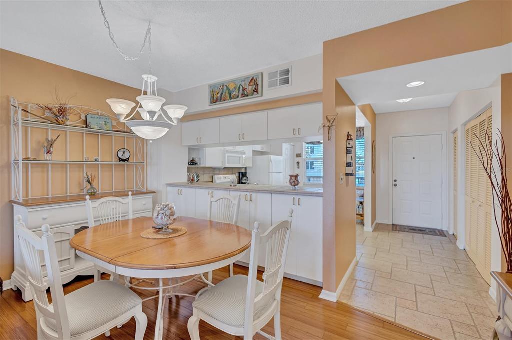 6475 Shoreline Drive, Unit 5102 St. Petersburg, FL 33708 - Photo 10 of 39 a kitchen with a dining table and chairs