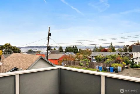 a view of a chairs and table in a balcony