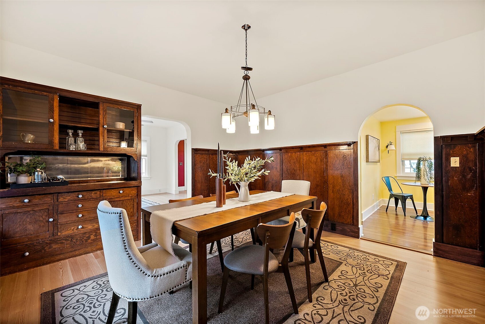 5207 North Pearl Street Ruston, WA 98407 - Photo 9 of 39 a dining room with furniture a chandelier and wooden floor