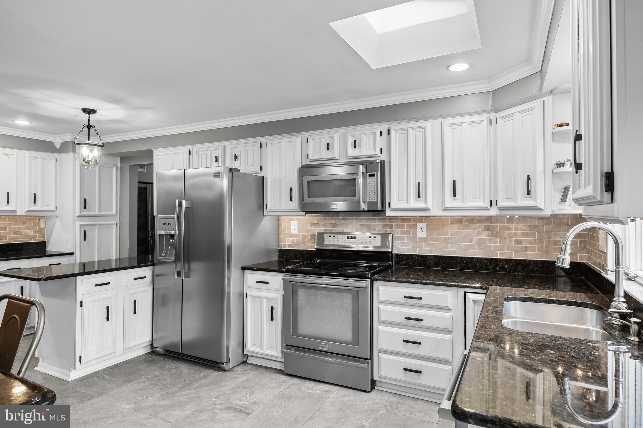2407 Riverton Road Cinnaminson, NJ 08077 - Photo 14 of 54 a kitchen with granite countertop a sink stove and refrigerator