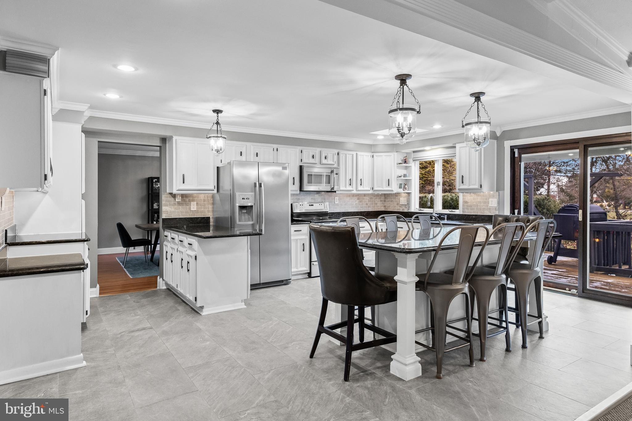 2407 Riverton Road Cinnaminson, NJ 08077 - Photo 17 of 54 a kitchen with kitchen island granite countertop wooden cabinets and center island