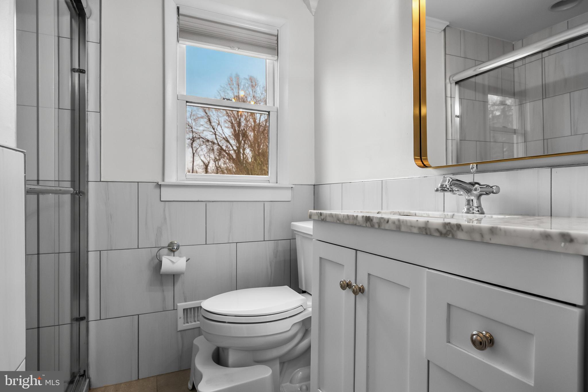 2407 Riverton Road Cinnaminson, NJ 08077 - Photo 30 of 54 a bathroom with a granite countertop toilet sink and mirror