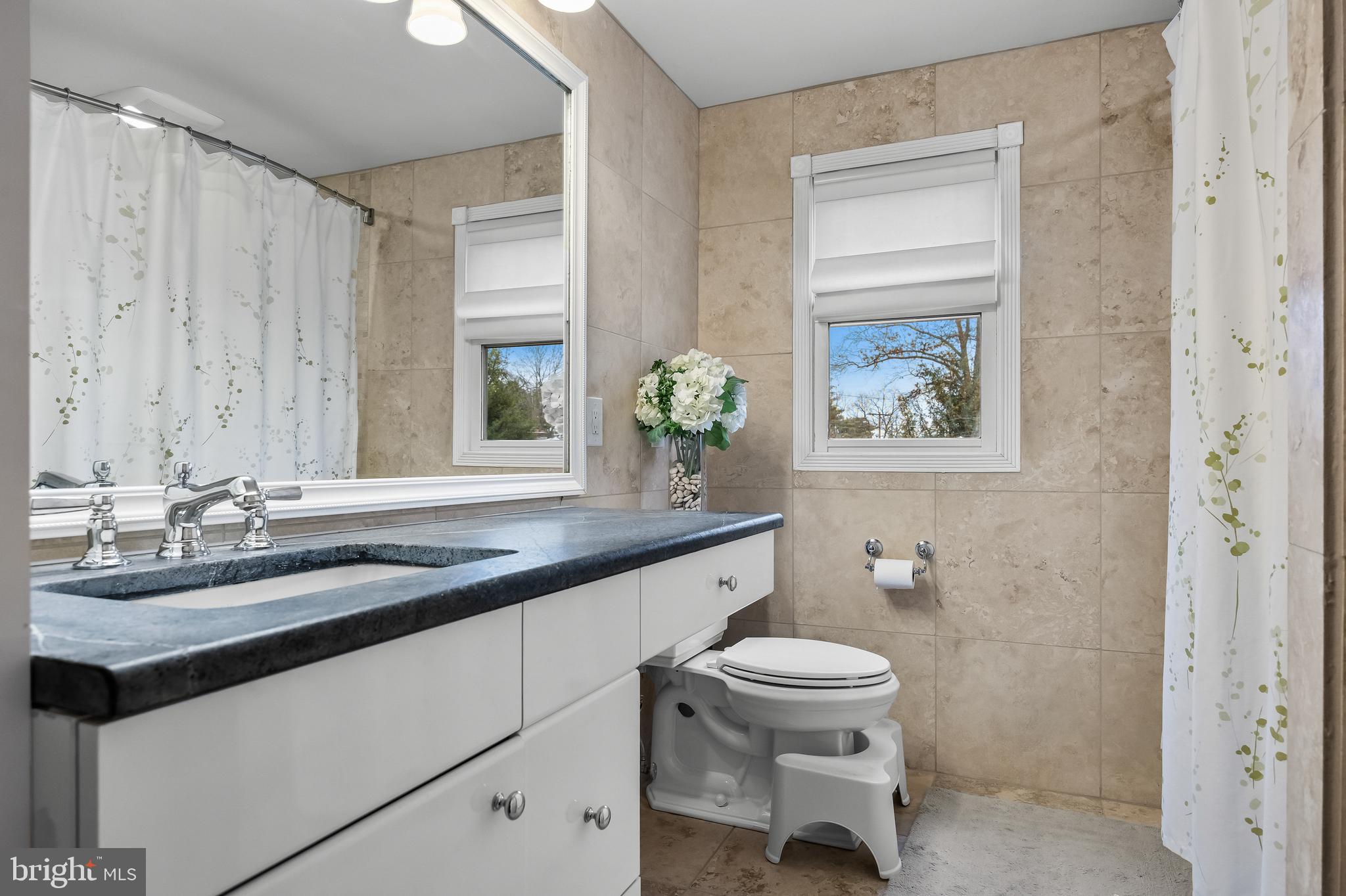 2407 Riverton Road Cinnaminson, NJ 08077 - Photo 32 of 54 a bathroom with a granite countertop sink toilet and a mirror