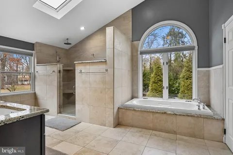 a living room with a large window and a fireplace