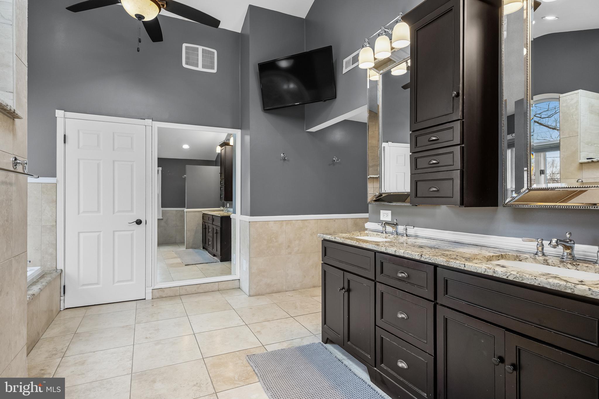 2407 Riverton Road Cinnaminson, NJ 08077 - Photo 38 of 54 a spacious bathroom with a granite countertop sink mirror and vanity