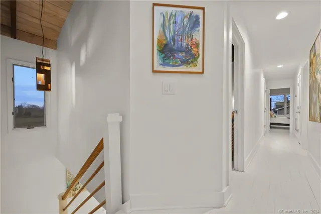 a view of a hallway with wooden floor and entryway