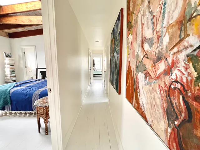 a view of hallway with furniture and a window
