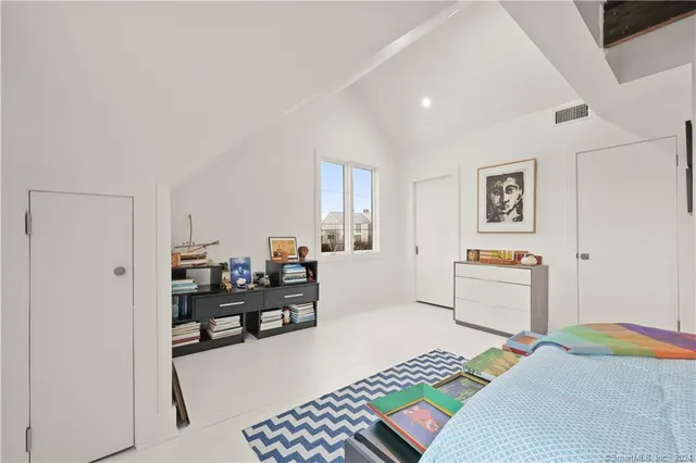 a bedroom with furniture and a window