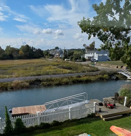 a view of a lake with a house in the background