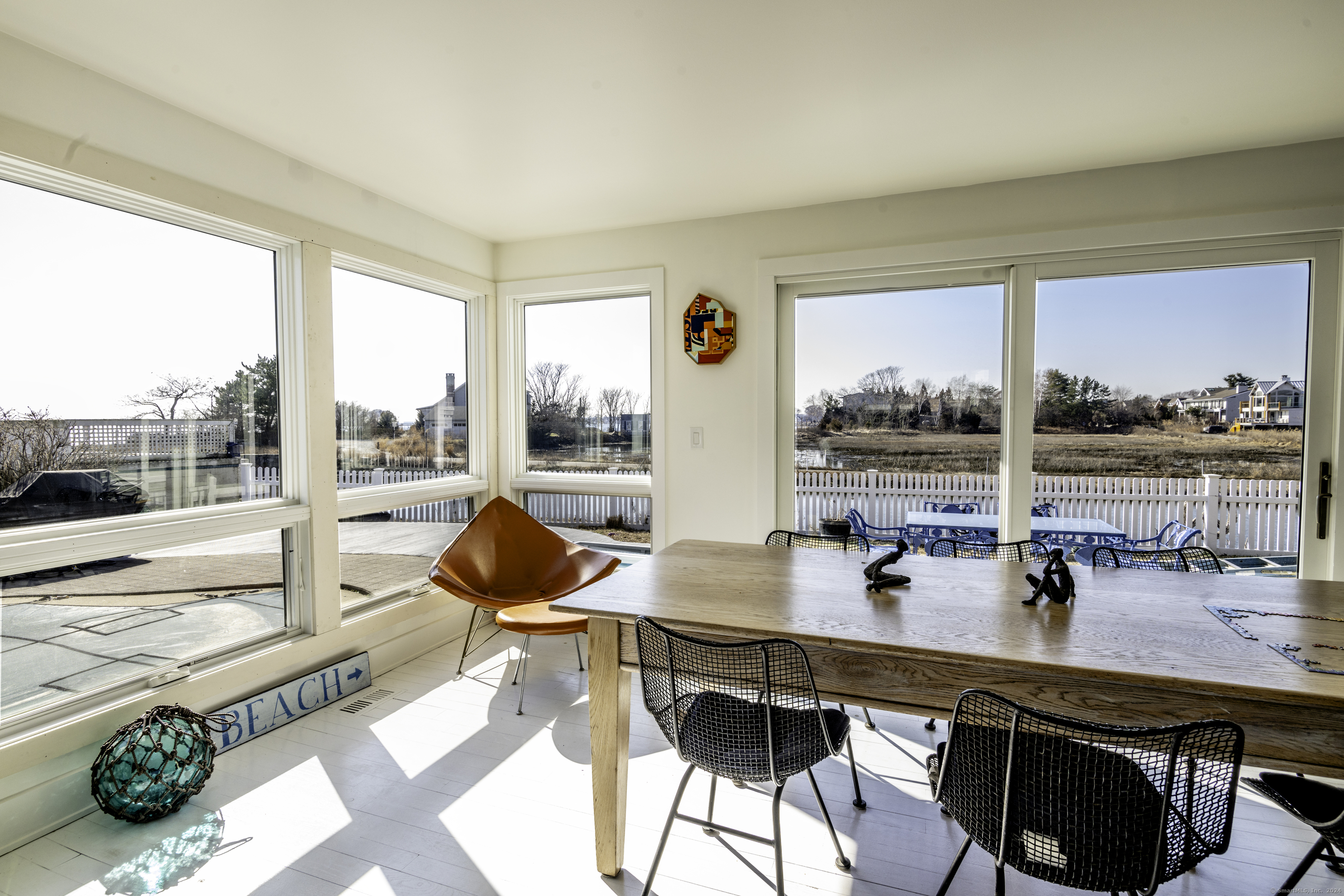 36 Spriteview Avenue Westport, CT 06880 - Photo 3 of 33 a view of a dining room with furniture large windows and wooden floor