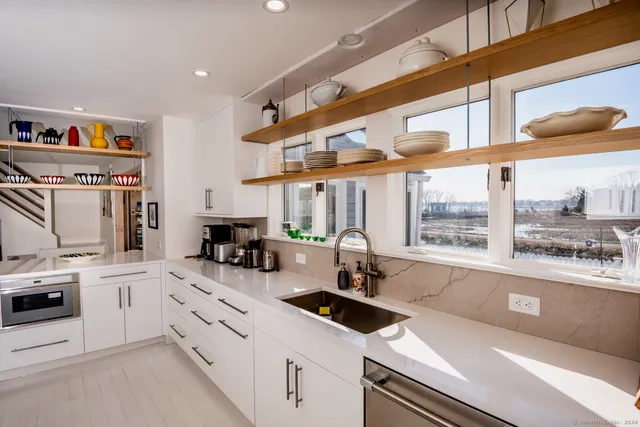 a kitchen with a sink a stove and cabinets