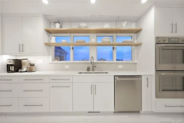 a kitchen with stainless steel appliances a sink and cabinets