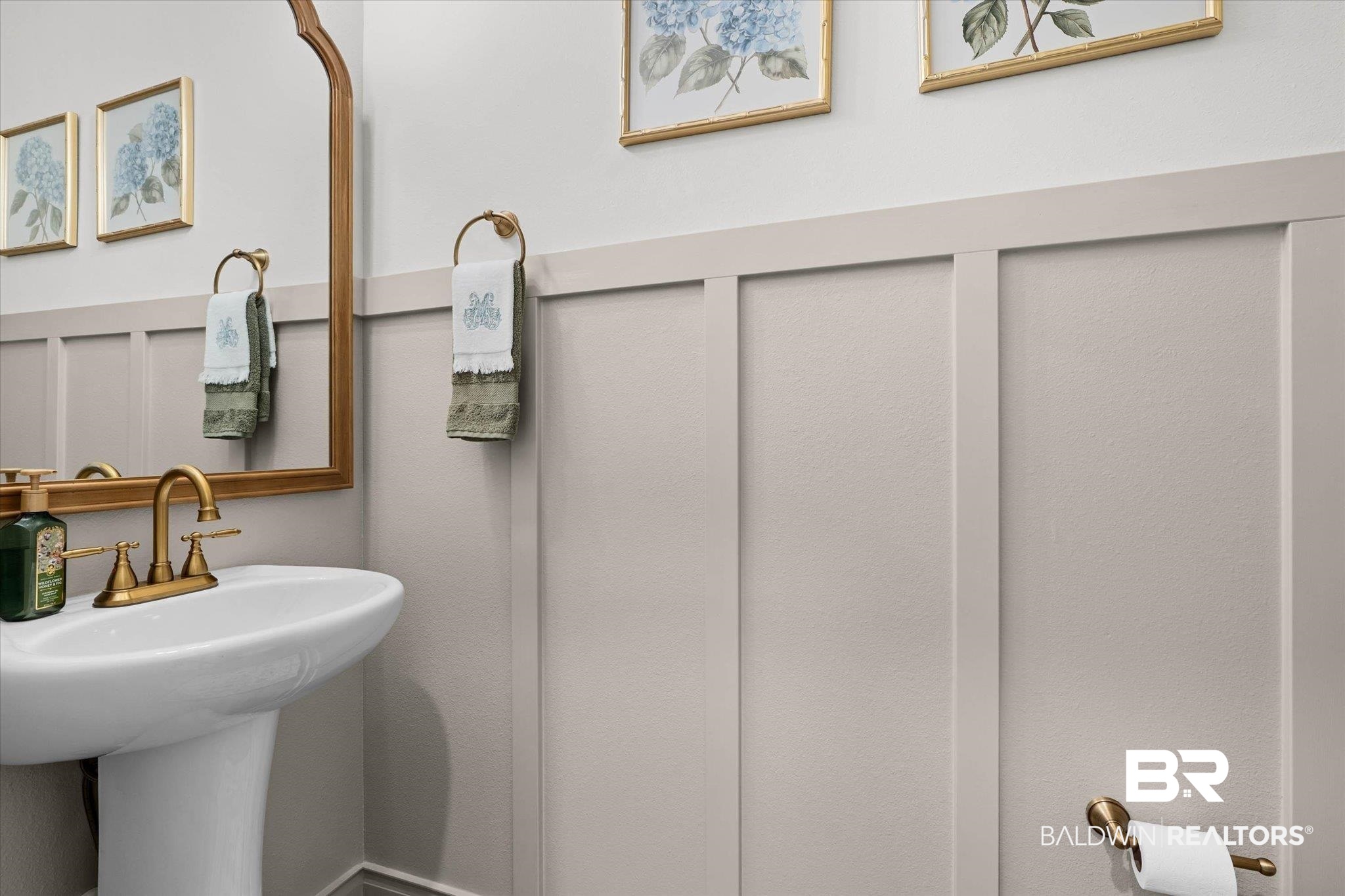 9074 Moses Way Theodore, AL 36582 - Photo 38 of 52 Pedestal sink with brass-finish faucet and mirror
