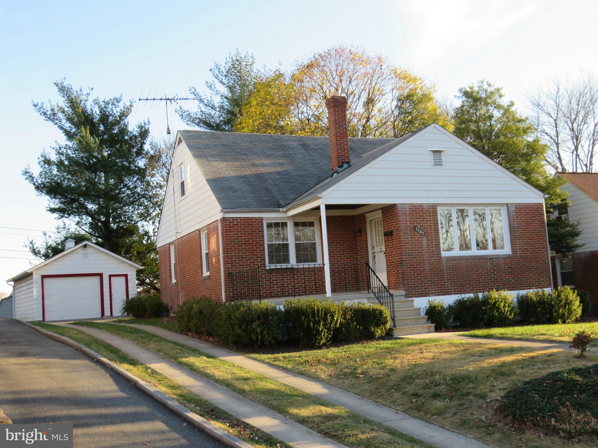 1747 Ellinwood Road Baltimore, MD 21237 - Photo 1 of 26 a front view of a house with a yard and garage